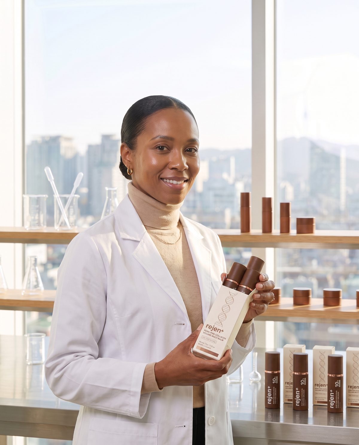 Tasha in her Seoul lab holding the rejen+ box